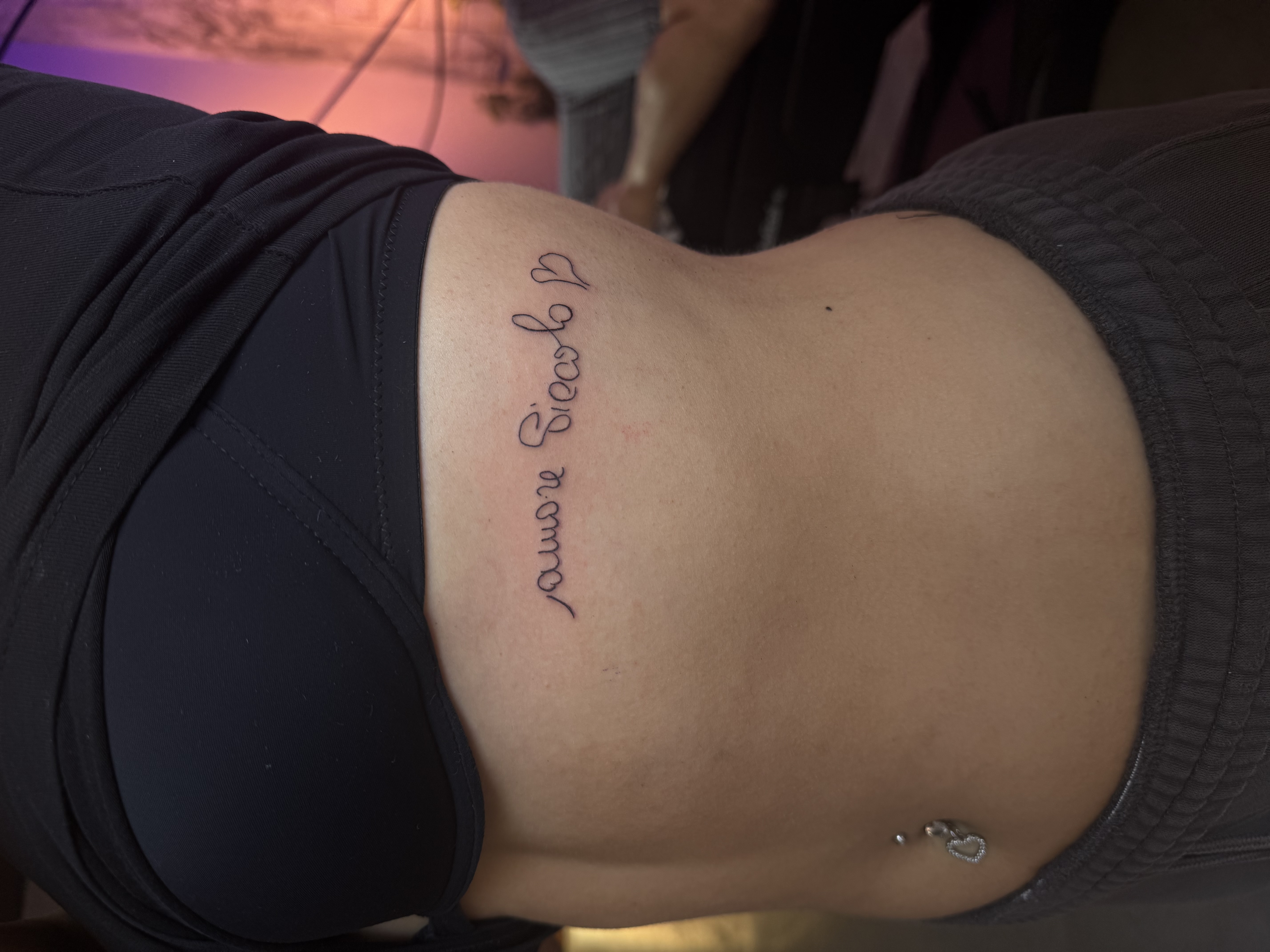 Tatuaggio lettering fine line sul fianco realizzato da Andrea N. Agnelli